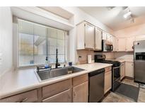 Bright kitchen features stainless steel appliances and ample cabinetry at 6701 Squaw Mountain Dr # 203, Las Vegas, NV 89130