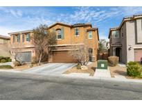 Two-story house with brown exterior, attached garage, and landscaping at 6966 Placid Lake Ave, Las Vegas, NV 89179