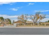 Single story home with landscaped yard and gated entrance at 7390 W Rome Blvd, Las Vegas, NV 89131