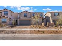 Charming two-story home featuring desert landscaping, a brick driveway, and an attached two-car garage at 745 Black Palace St, Henderson, NV 89011