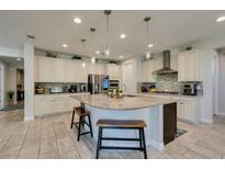 Gourmet kitchen featuring granite island, stainless steel appliances, and custom cabinetry at 9994 Celestial Cliffs Ave, Las Vegas, NV 89166