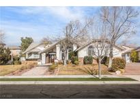 Single-story house with a large front yard, stone accents, and a three-car garage at 1010 Legacy Dr, Boulder City, NV 89005