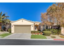 Single-story home with attached garage and landscaped front yard at 10228 Questa Sera Ct, Las Vegas, NV 89135