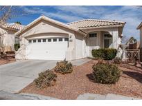 Single-story house with a two-car garage and well-maintained landscaping at 10540 Beachwalk Pl, Las Vegas, NV 89144