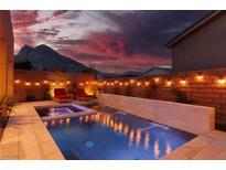 Stunning backyard oasis featuring a sparkling pool, spa, and outdoor lighting at 10936 White Alder Pl, Las Vegas, NV 89138