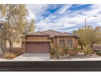 Inviting single-story home with tile roof, desert landscaping, and a two car garage at 11106 Cherokee Landing St, Las Vegas, NV 89179