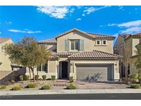 Two-story house with tan siding, tile roof, and landscaped front yard at 12846 Ringrose St, Las Vegas, NV 89141