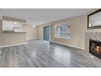 Bright living room with fireplace and wood-look floors at 1575 W Warm Springs Rd # 911, Henderson, NV 89014