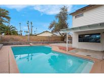 Inviting swimming pool with diving board, spacious patio, and surrounding landscape at 2923 Palora Ave, Las Vegas, NV 89121