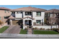 Two-story house with modern design, attached garage, and landscaped yard at 304 Elder View Dr, Las Vegas, NV 89138