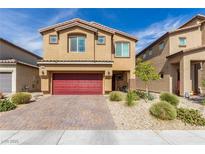 Two-story house with red garage door and landscaped yard at 4036 Floating Fern Ave, North Las Vegas, NV 89084