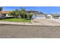 House exterior featuring a two-car garage and well-maintained lawn at 722 Barrie Ct, Henderson, NV 89002