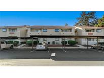 Exterior view of apartment building with carport and parking spaces at 7300 Pirates Cove Rd # 2013, Las Vegas, NV 89145