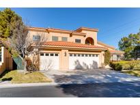 Beautiful two-story house with a three-car garage and nicely landscaped front yard at 8600 Kiel Ridge Cir, Las Vegas, NV 89117