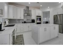 Spacious kitchen with white cabinets, stainless steel appliances, and marble countertops at , Las Vegas, NV 89128