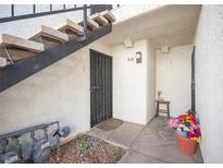 Condo entrance featuring secure door, concrete stairs and walkway with rock landscaping at 1701 E Katie Ave # 65, Las Vegas, NV 89119
