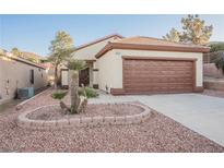 Single-story home with a two-car garage and landscaped front yard at 1859 Cypress Greens Ave, Henderson, NV 89012