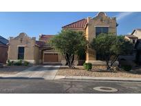 Two-story house with Spanish-style architecture and landscaping at 2821 White Peaks Ave, North Las Vegas, NV 89081