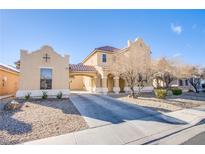 Inviting home with covered driveway, two-story design, and low-maintenance desert landscaping at 2821 White Peaks Ave, North Las Vegas, NV 89081