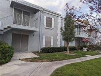 Two-story condo featuring balconies, neutral stucco, white trim, and stairs to upper unit at 3823 S Maryland Pkwy # C3, Las Vegas, NV 89119