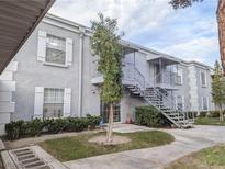 Two story condo featuring white trim windows, exterior stairs, and green landscaping at 3823 S Maryland Pkwy # C3, Las Vegas, NV 89119