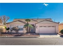 One-story house with tile roof, two-car garage, and desert landscaping at 4507 Golden Palomino Ln, North Las Vegas, NV 89032