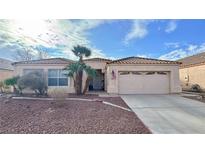 One-story house with tile roof, desert landscaping, and two-car garage at 4507 Golden Palomino Ln, North Las Vegas, NV 89032