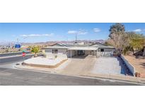 Charming single-story home with a covered carport and desert landscaping at 601 Sierra Ln, Henderson, NV 89002