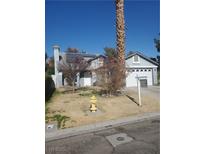 House exterior featuring a gray color scheme, solar panels, and a spacious yard at 6136 Evensail Dr, Las Vegas, NV 89156