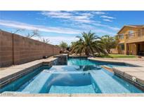 Inviting pool and spa with a palm tree and spacious backyard at 6165 Smarty Jones Ave, Las Vegas, NV 89131