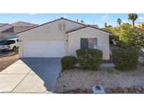 Single-story house with a two-car garage and well-manicured landscaping at 7909 Dutch Canyon Ct, Las Vegas, NV 89131