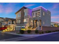 Modern two-story home with a stacked stone accent, two-car garage, and a beautifully landscaped front yard at 8620 Grove Mill Ct, Las Vegas, NV 89139