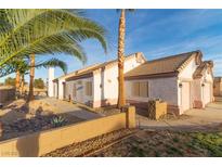 Desert landscape and charming single-story home with a three-car garage at 1215 Country Club Dr, Laughlin, NV 89029