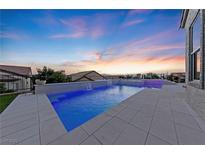 Relaxing pool with spa and water feature at sunset at 1999 Oliver Springs St, Henderson, NV 89052