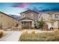 Two-story house with gray siding, brown door, landscaping, and a sidewalk at 2499 Adige Pl, Henderson, NV 89044