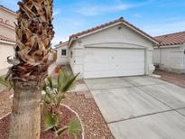 House exterior with a white finish, two-car garage, and desert landscaping at 4648 Skybolt St, Las Vegas, NV 89115