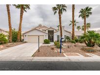 Inviting single-story home with desert landscaping and mature palm trees at 5416 Lochmor Ave, Las Vegas, NV 89130