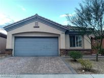 Single-story home with a two-car garage and a landscaped front yard at 56 Island Course Ave, Las Vegas, NV 89148