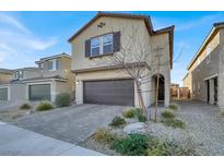 Inviting two-story home featuring a two-car garage, desert landscaping, and a classic red tile roof at 7011 Toll Mountain St, North Las Vegas, NV 89086