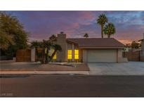 Single-story home with a two-car garage, landscaping, and a modern design at 911 Pescados Dr, Las Vegas, NV 89123