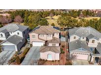 Aerial view of two-story house with solar panels, pool, and landscaped yard at 1551 Boundary Peak Way, Las Vegas, NV 89135