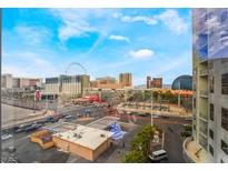 Bright city view showcasing the High Roller Observation Wheel and nearby buildings against a cloudy blue sky at 211 E Flamingo Rd # 412, Las Vegas, NV 89169