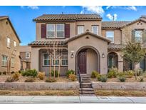 Charming two-story home with a covered entry, landscaped front yard, and inviting curb appeal at 2436 Padulle Pl, Henderson, NV 89044