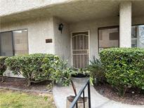 Inviting condo entry with well-manicured landscaping at 2638 Aracatuba Ave, Las Vegas, NV 89121