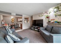 Spacious living room with comfy couches and a large TV at 5261 Mission Carmel Ln # 202, Las Vegas, NV 89107