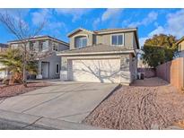 Two-story house with a two-car garage and landscaped yard at 6134 Riflecrest Ave, Las Vegas, NV 89156