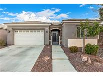 Charming single-story home featuring stone accents, a two-car garage, and well-maintained landscaping at 6886 Barred Dove Ln, North Las Vegas, NV 89084