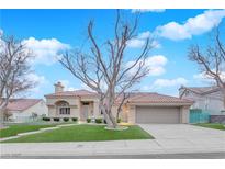 Charming single-story home featuring a red tile roof, manicured lawn, and an attached two-car garage at 9609 Eagle Valley Dr, Las Vegas, NV 89134