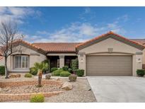 Single-story house with a two-car garage and landscaped front yard at 10525 Findlay Ave, Las Vegas, NV 89134