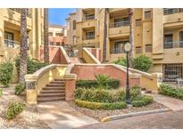 Attractive building exterior with well-maintained landscaping and walkway at 230 E Flamingo Rd # 412, Las Vegas, NV 89169